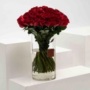 This bouquet of 30 red roses in a sleek cylinder vase